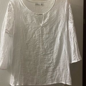 White lace top 3/4 bell sleeve and silver accents at the neck line.